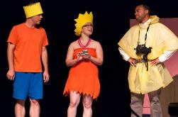 Kevin Kinder as Bart Simpson and Erin Spandorf as Lisa Simpson get lectured by a hazardous waste responder played by Justin Stewart.