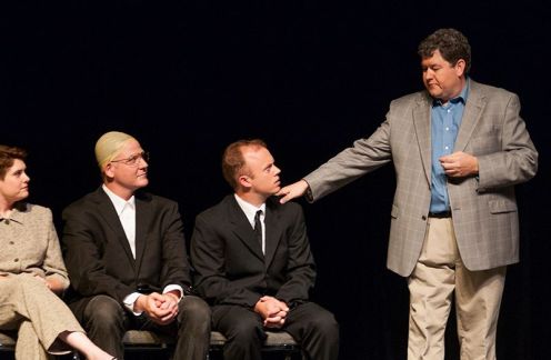 Ray Minor provides bad news to the university administration, played by Sarah Warnock, Zeek Martin and Kevin Kinder.